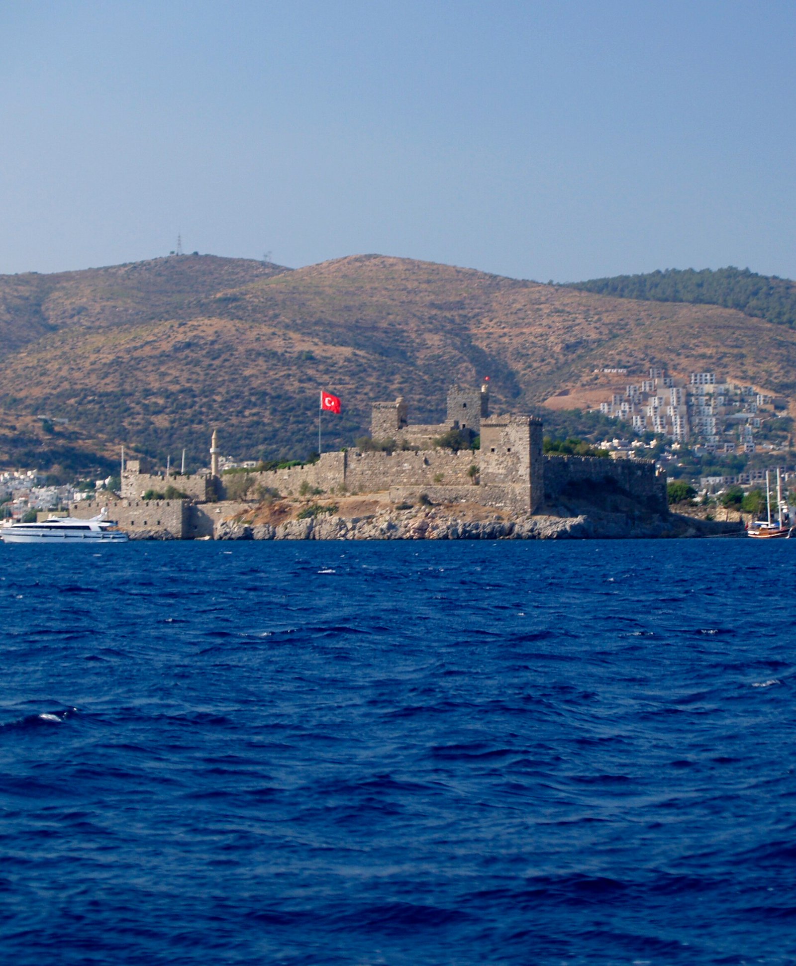 Whitewashed Bodrum buildings and the castle above the Aegean harbor