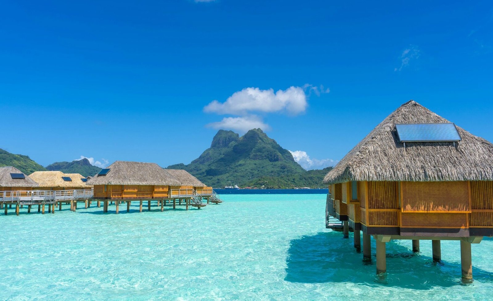 Overwater bungalows across Bora Bora’s clear blue lagoon