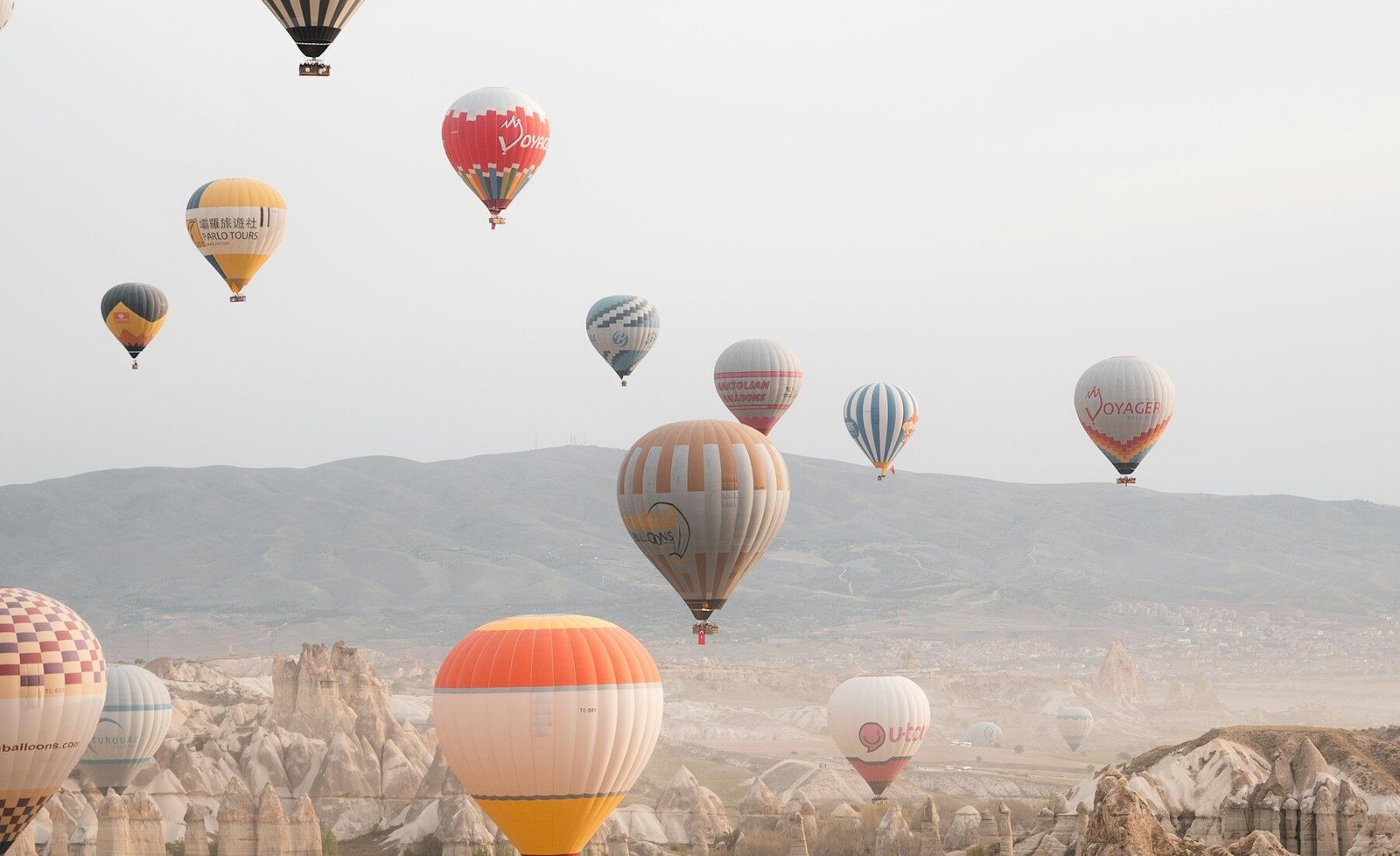 Hot-air balloons floating above Cappadocia at sunrise