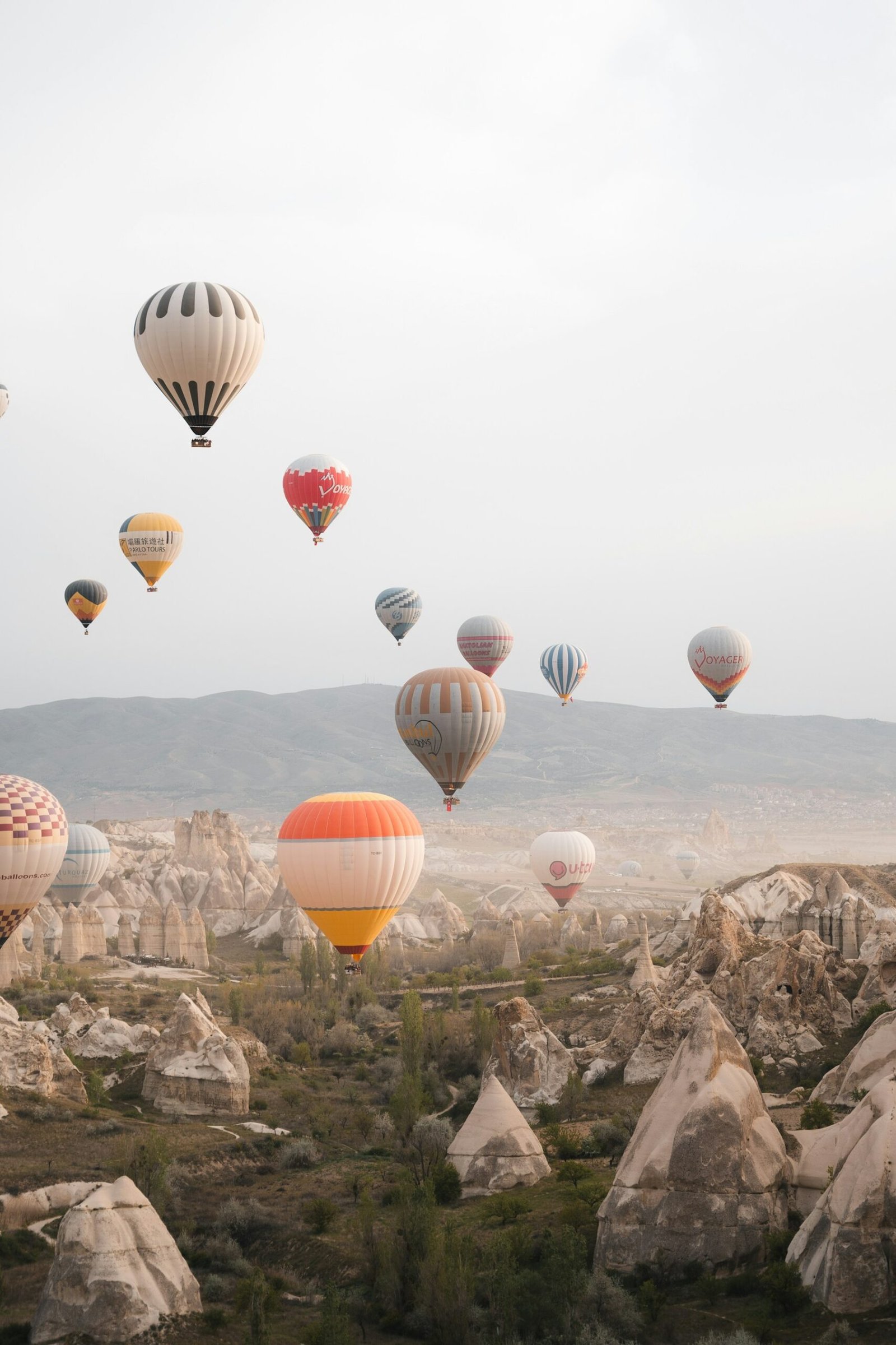 Hot-air balloons floating above Cappadocia at sunrise