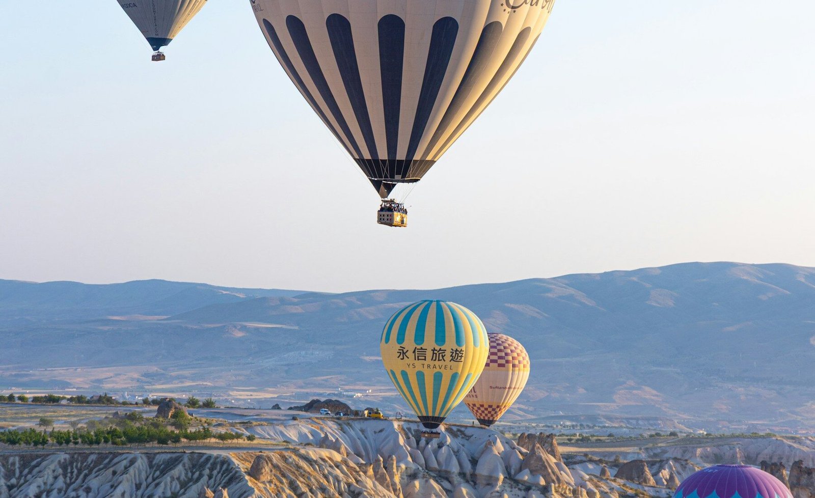 Colorful balloons above Cappadocia’s rocky valleys