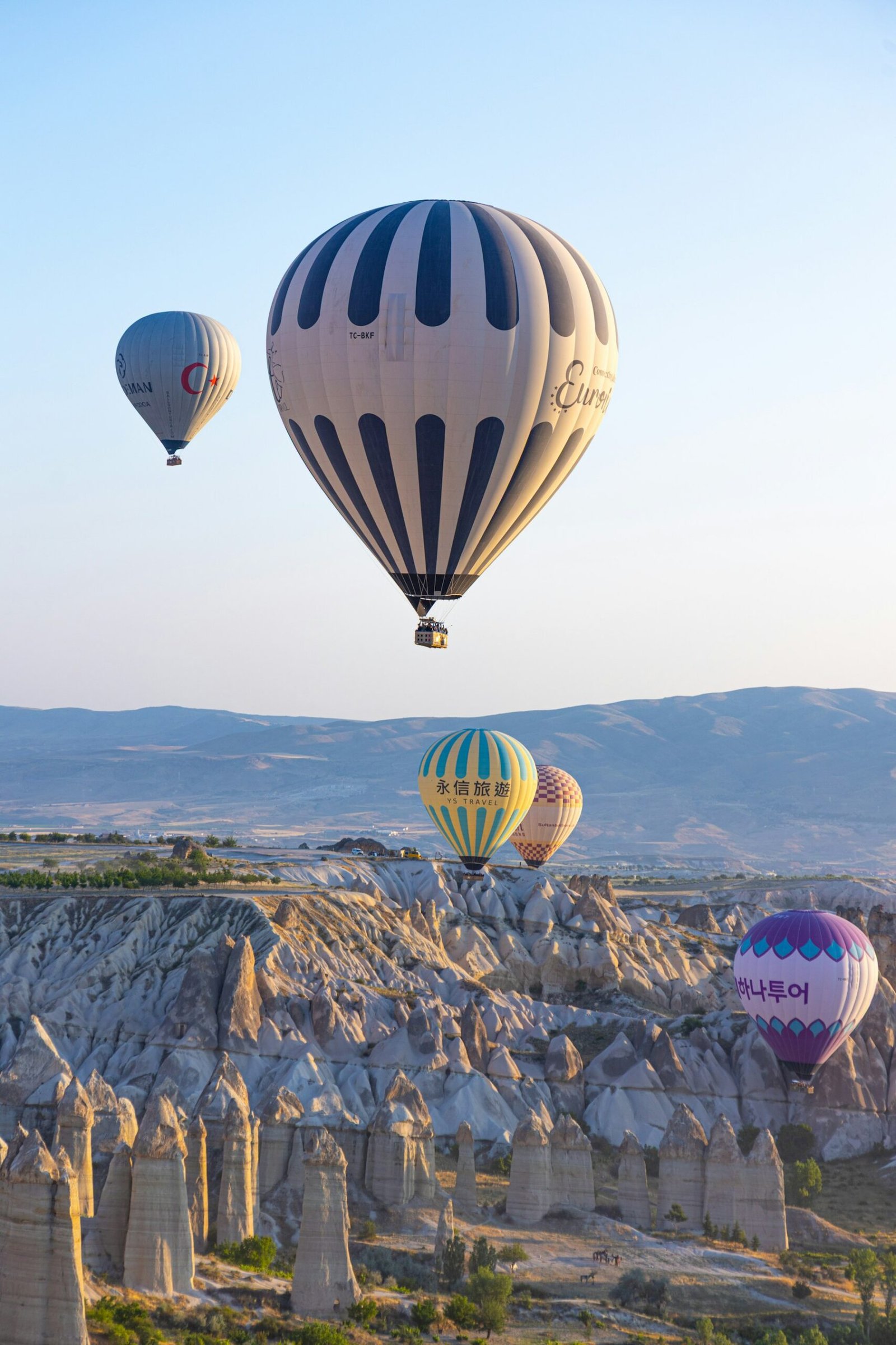 Colorful balloons above Cappadocia’s rocky valleys