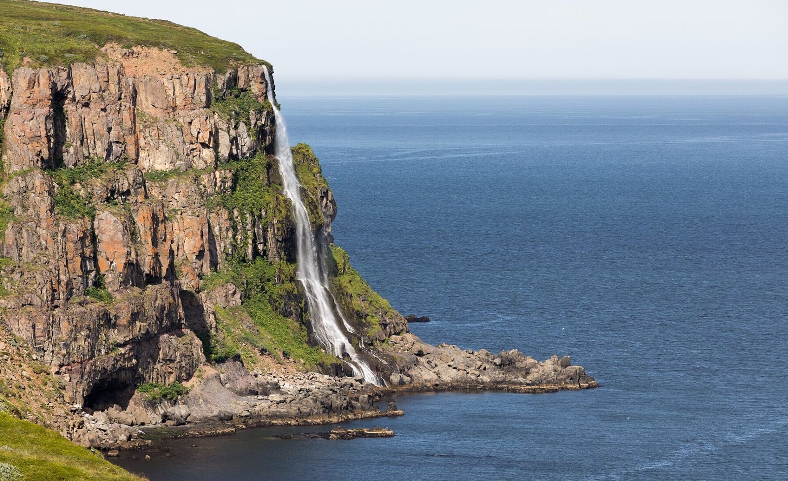 Migandi waterfall descending from Icelandic cliffs