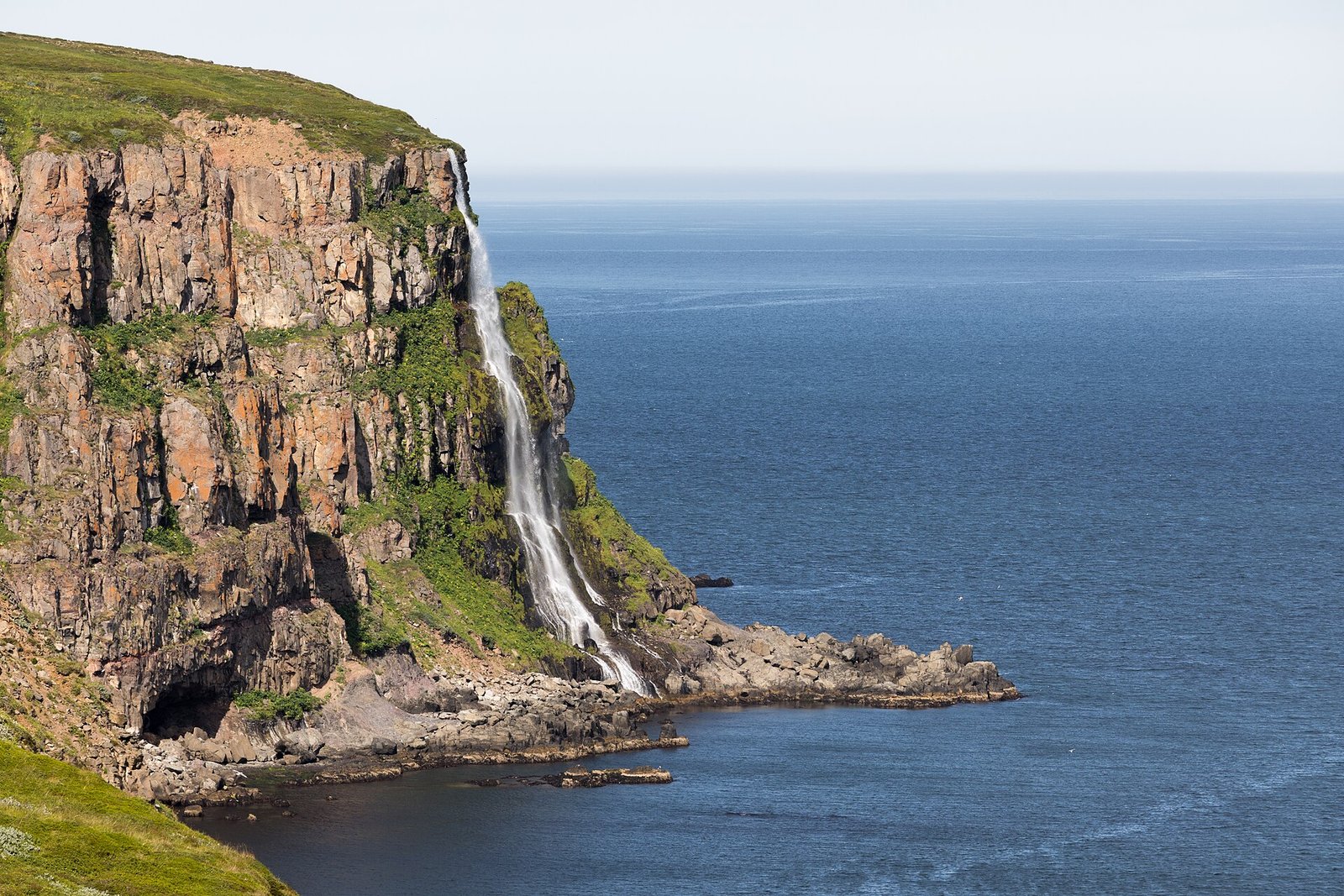 Migandi waterfall descending from Icelandic cliffs