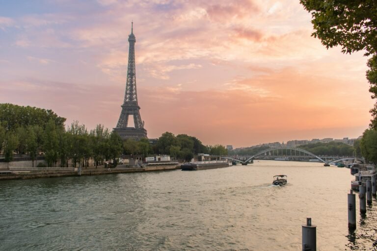 The Eiffel Tower rising above Paris at sunset