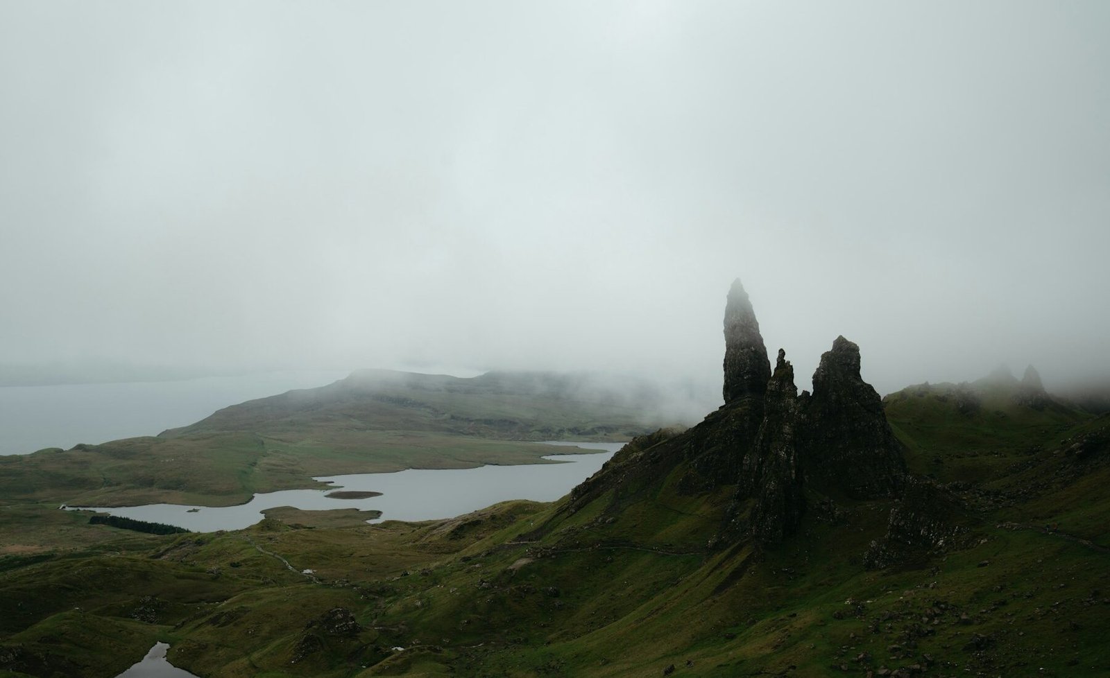 Old Man of Storr above a misty loch on the Isle of Skye