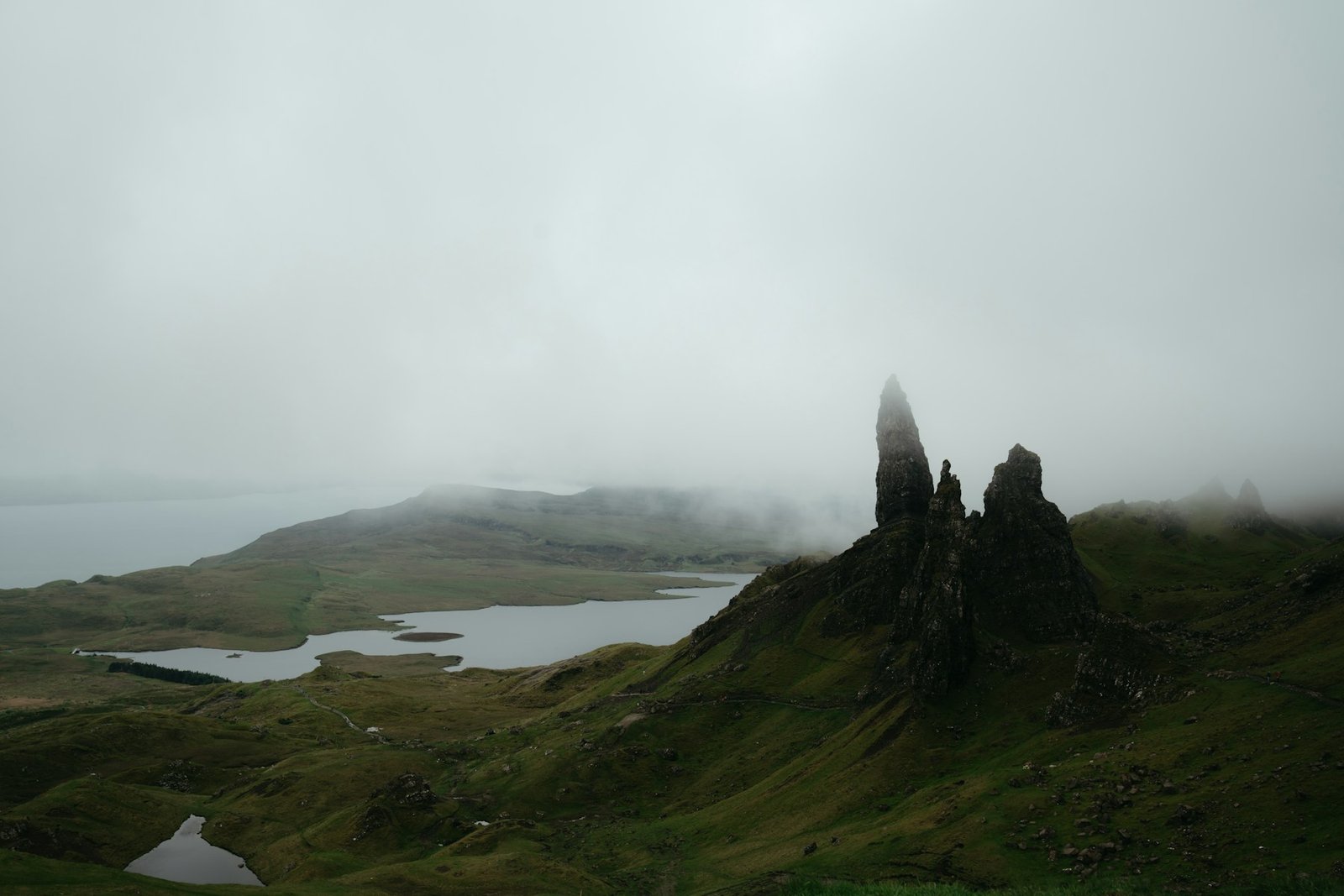 Old Man of Storr above a misty loch on the Isle of Skye